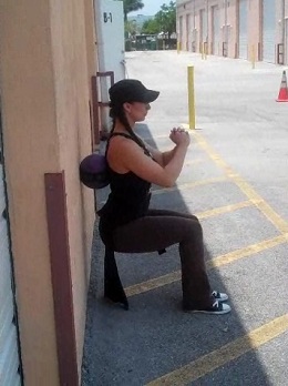 Medicine Ball Wall Hold to Squats Start Position