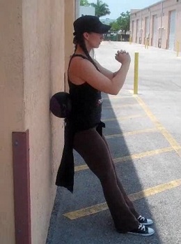 Medicine Ball Wall Hold to Squats Finish Position